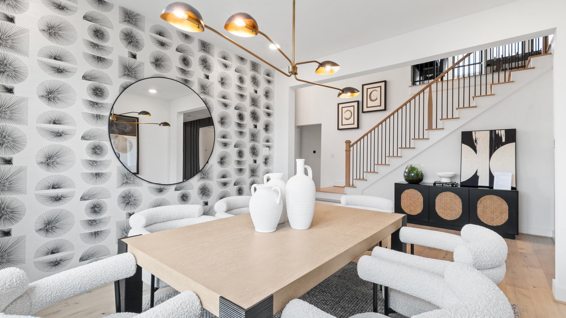 Dining room with patterned wallpaper and staircase in a new construction home for sale in the Greater Austin area